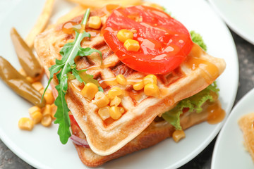Delicious waffles with vegetables on plate, closeup