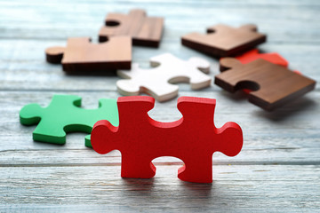 Pieces of puzzle on wooden background