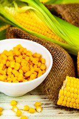 Ripe corn on a wooden table close-up.