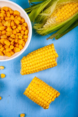 Ripe corn on a blue table close-up.