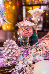 Christmas card, photo, background. Glasses of candy, cones of Christmas trees with Christmas tinsel, spruce branches. Place and background for text.