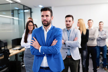 Successful team of young perspective businesspeople in office