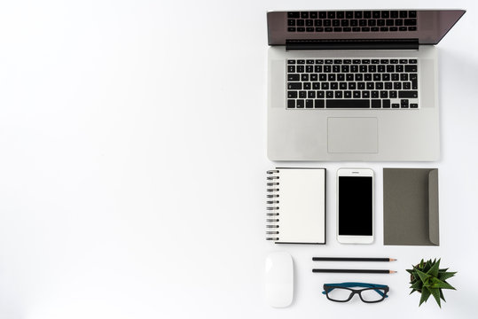 Office desktop with laptop and accessories. Top view