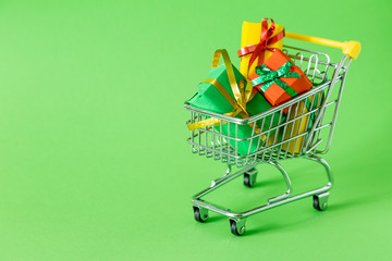 Online shopping concept - trolley cart full of presents. Black Friday and Ciber Mondey
