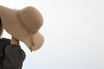 Elegant woman in hat on white background, space for text