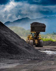 Coal: loader moving a pile of coal at a coal mine on Vancouver Island