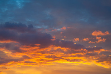 Naklejka na ściany i meble Dramatic view on a orange clouds in evening sky