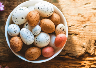 White large bowl on the table. With quail eggs