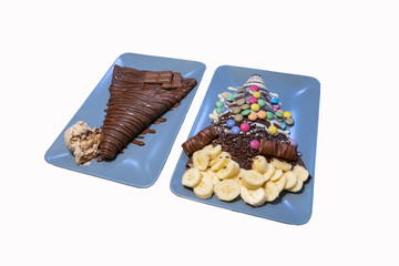 Chocolate pancakes isolated on white background. Pancakes with chocolate, bananas and nuts.