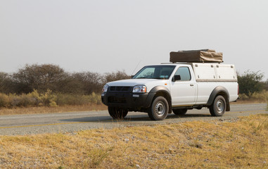 Obraz na płótnie Canvas Pickup truck driving in Botswana