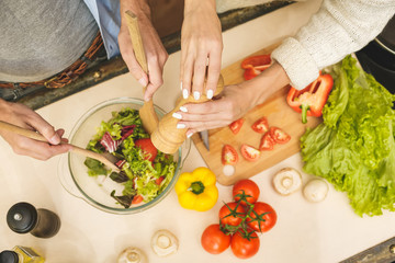 Top view of lovely couple are talking and while cooking healthy food in kitchen at home. Close-Up.