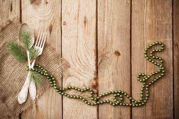 Christmas table place setting on wooden background