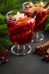 Christmas Mulled Wine with Apple, Orange and Cranberries. Holiday Concept Decorated with Fir Branches, Cranberries and Spices.