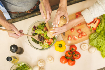 Top view of lovely couple are talking and while cooking healthy food in kitchen at home. Close-Up.