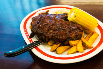Grilled steak - Grilled meat ribs on the plate with hot sauce