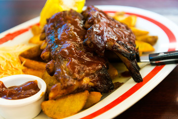 Grilled steak - Grilled meat ribs on the plate with hot sauce