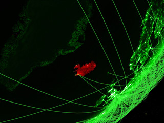 Iceland on green model of planet Earth with network at night. Concept of green technology, communication and travel.
