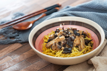 close-up of plate of pasta and chicken with lettuce