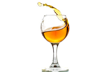 A round glass with brandy and a splash of drink inside
