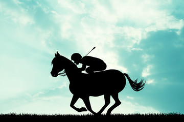jockey on horseback at sunset