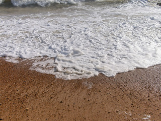 Wave of the sea on the sand beach