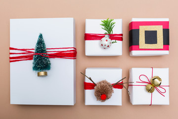 Variety of Christmas gift boxes on a light brown paper background