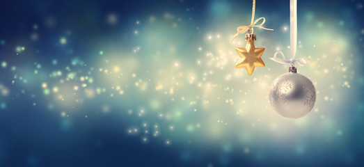 Christmas star and bauble ornaments in snowy night