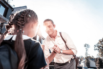 Modern father. Stylish modern loving and caring father with tattoo on hand taking his little girl to school