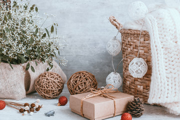 Beautiful Christmas background with decorations and gift boxes on wooden board. Red ribbon, pine cones, baubles. Copy space, greeting card