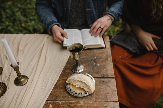 christian couple reading the bible and taking communion