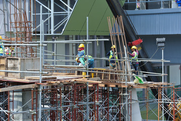 Construction workers working at the construction site at Seremban, Malaysia during daytime. They...