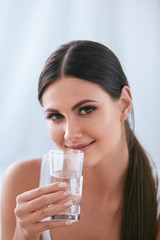 Happy Woman Drinking Water. Beautiful Female With Glass Of Water