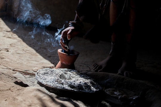 Smoke rises from clay pot for ash used by Himba tribe