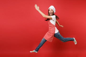 Housewife female chef cook or baker in striped apron white t-shirt, toque chefs hat isolated on red...