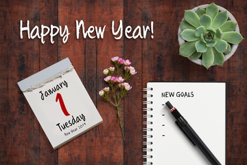 tear-off calendar with 1st of january 2019 and notebook with checklist of "new goals"