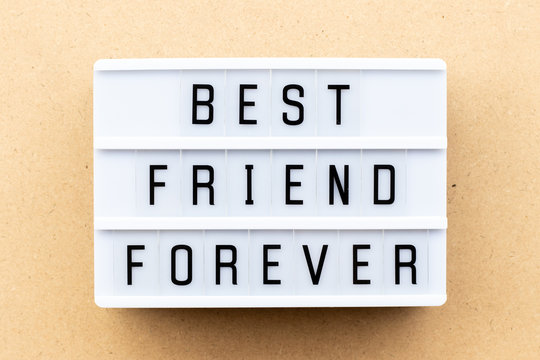Light box with word best friend forever on wood background