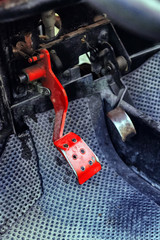 Old car - buggy, shabby red brake pedal in focus