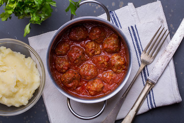 close up of meatballs, tomato sauce and mash
