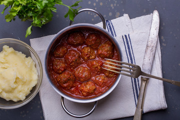close up of meatballs, tomato sauce and mash
