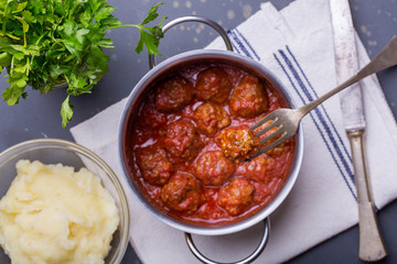 close up of meatballs, tomato sauce and mash