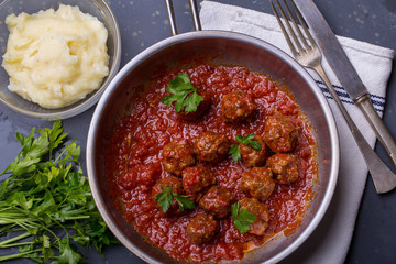 close up of meatballs, tomato sauce and mash