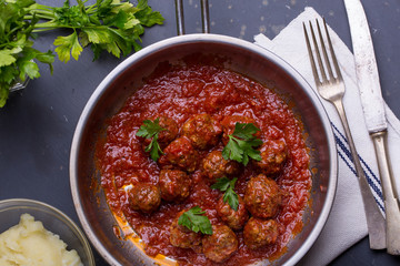 close up of meatballs, tomato sauce and mash