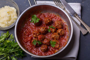 close up of meatballs, tomato sauce and mash