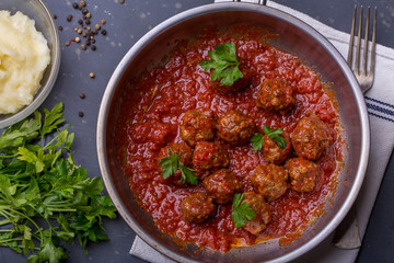 close up of meatballs, tomato sauce and mash