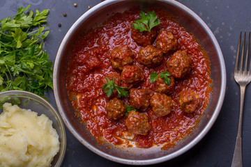 close up of meatballs, tomato sauce and mash