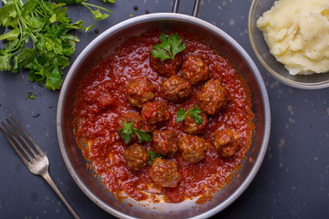 close up of meatballs, tomato sauce and mash