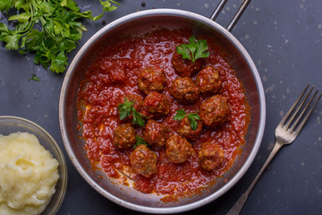 close up of meatballs, tomato sauce and mash