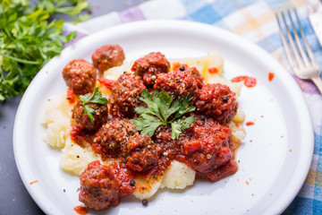 Tasty details of tomato meatballs with mash