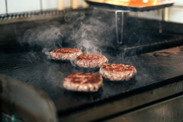 Tasty burger meat on a grill. Close-up.