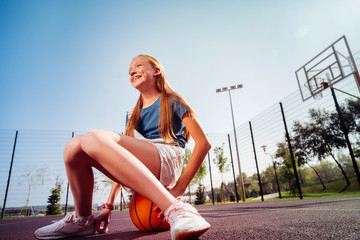 Having break. Kind longhaired girl expressing positivity while waiting for her friends